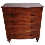 A Victorian mahogany bow front chest of two short over three long drawers, bun handles, raised on