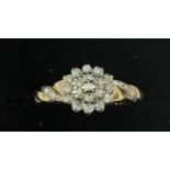 A white gold diamond cluster ring, claw set brilliant cut stones.