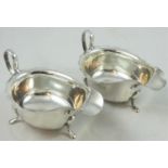 A pair of silver sauce boats, Sheffield 1932/33, with wavy edges, raised on three pad feet, 15 cm,