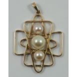 A 9ct gold and pearl pendant, the graduated cultured pearls set in an abstract design, 7.5 gms.