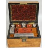 A Victorian mahogany travelling vanity case, the hinged cover opening to reveal a drop down