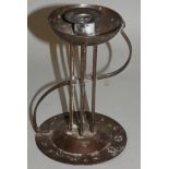 An Austrian Secessionist iron candlestick, by Hugo Berger, c.1900, the sconce supported by six