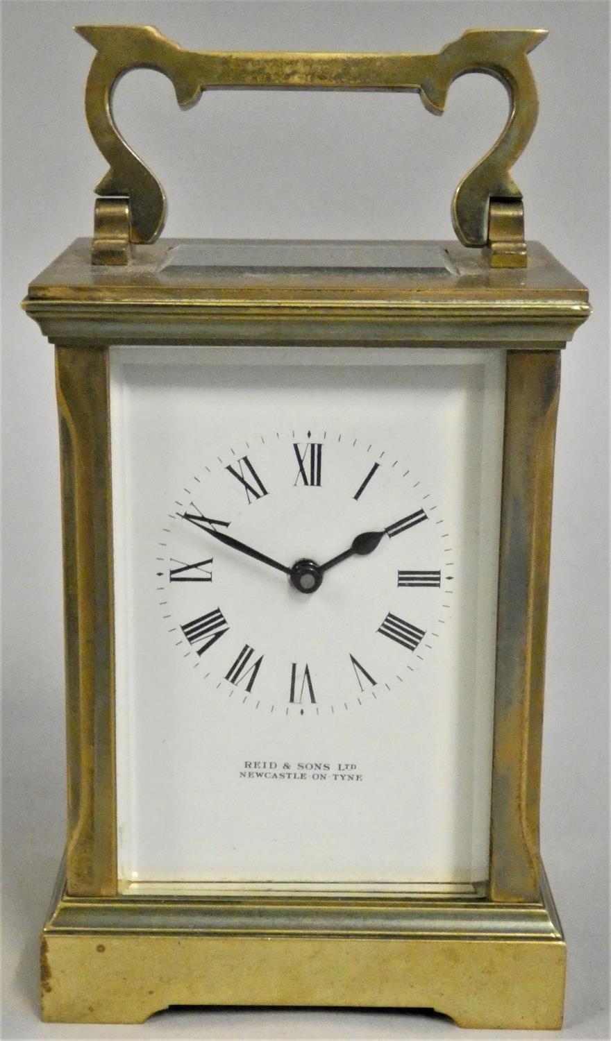 A brass carriage timepiece, retailed by Reid & Sons Ltd., Newcastle on Tyne, white enamel dial