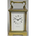 A brass carriage timepiece, retailed by Reid & Sons Ltd., Newcastle on Tyne, white enamel dial