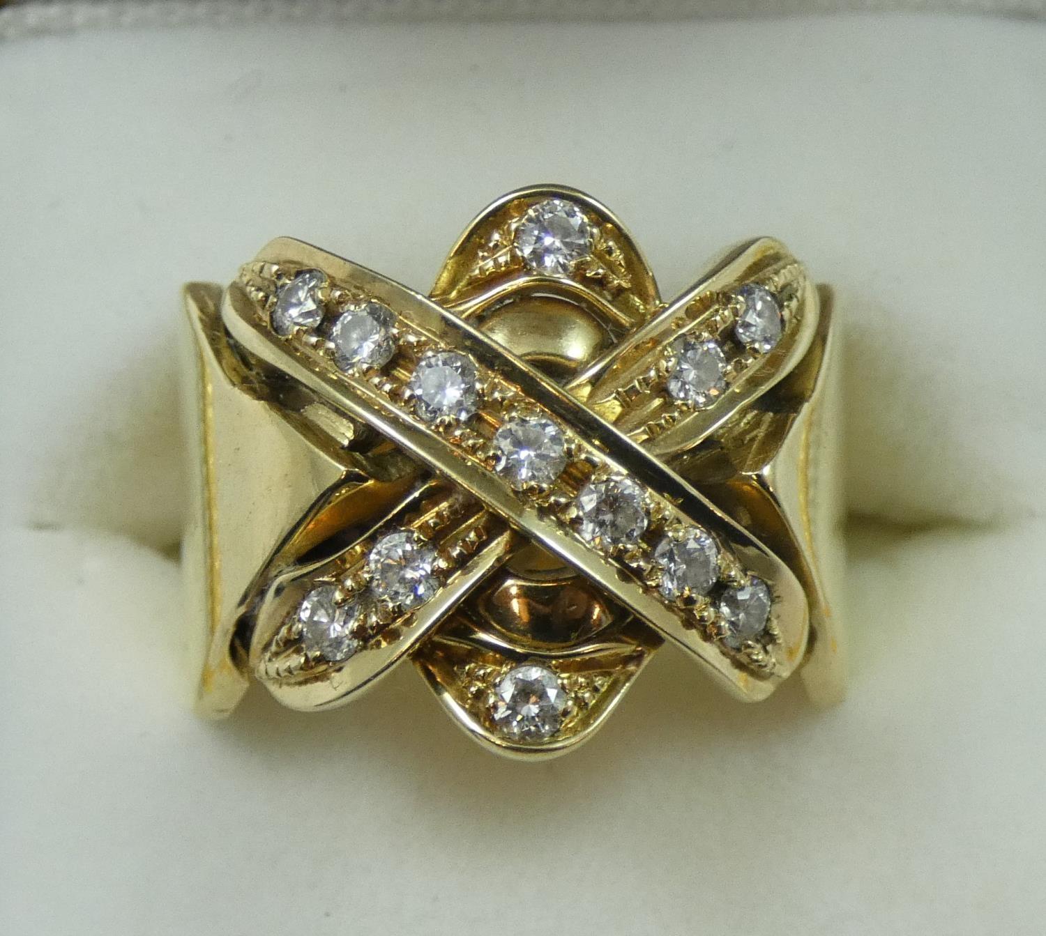 A gold and diamond dress ring, the cross motif set with 13 brilliant cut stones, weight