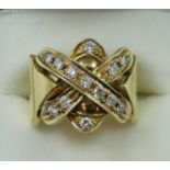 A gold and diamond dress ring, the cross motif set with 13 brilliant cut stones, weight