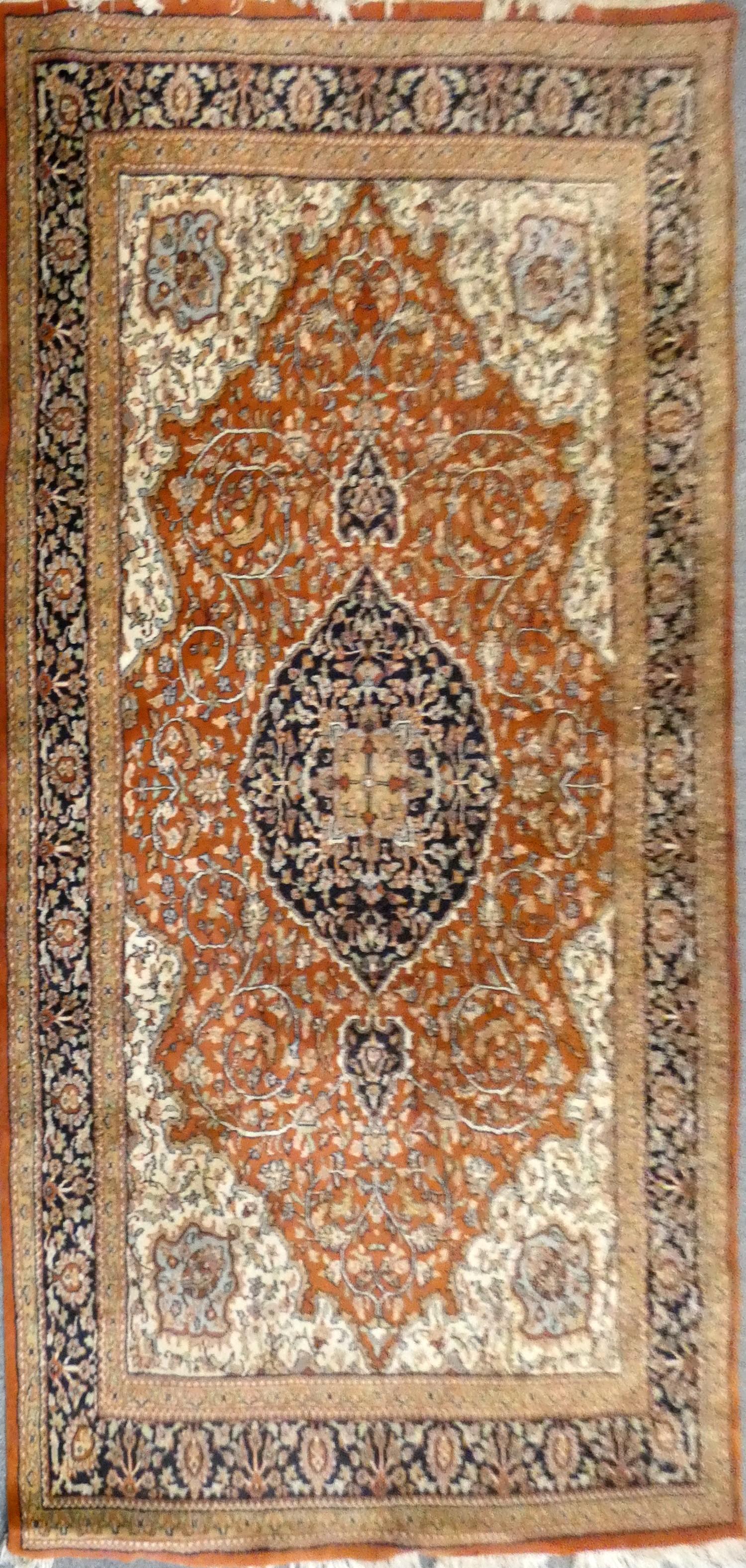 A Persian Jaipur wool rug, with burnt orange and black field, 275 x 185 cm