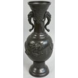 A late 19th century Chinese bronze vase, of baluster form with applied dragon chasing the sacred