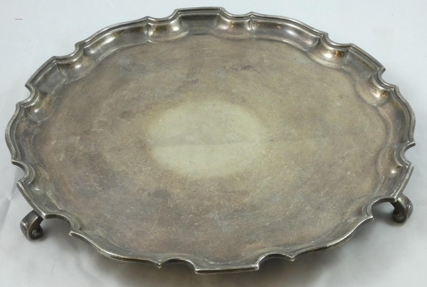 A silver circular salver, Birmingham 1934, Coronation duty mark; with Chippendale border raised on