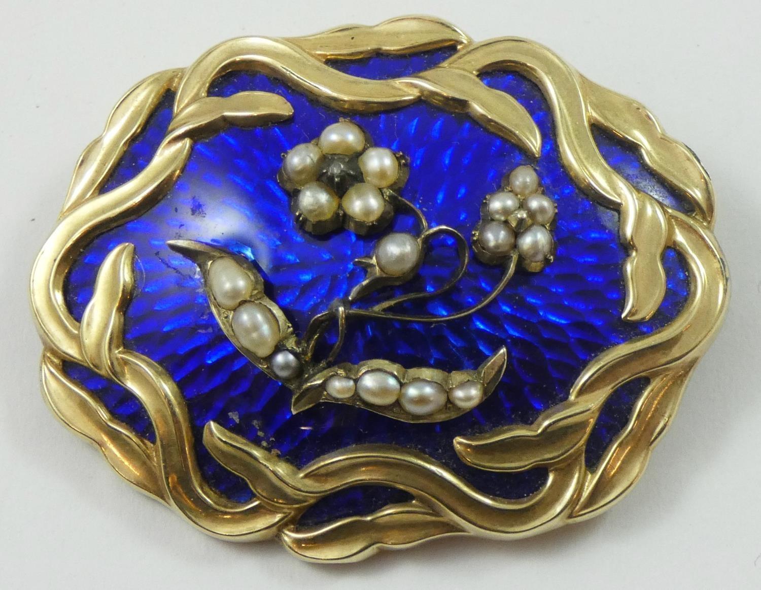 A Victorian gold, blue enamel and pearl mourning brooch, the forget me knot motif applied to a