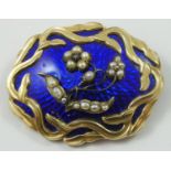 A Victorian gold, blue enamel and pearl mourning brooch, the forget me knot motif applied to a