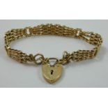 A 9ct gold fancy gate link bracelet, London 1979, with engraved heart padlock, 19.5 gms.