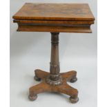 A Regency rosewood fold over games table, the swivel top opening to reveal a baize cover, raised