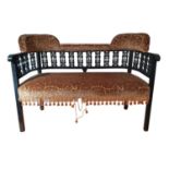 An Edwardian ebonised beech sofa, the upper section with turned bobbin supports, upholstered seat,