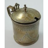 A Victorian silver mustard pot, London 1868, of circular form with bright cut engraved decoration,