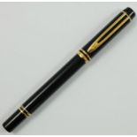 A Waterman 100 rollerball pen, with black lacquer body and gilt mounts.