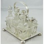 An electroplate six bottle table cruet, the frame with scroll handle, raised on four ball feet,