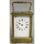 A French brass striking carriage clock, the white enamel dial with Roman numerals and retailer