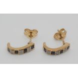 A pair of 9ct gold sapphire and diamond earstuds, set with square and single cut stones.