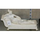 A semi-nude lady made of resin reclining on a chaise longue, indistinctly signed, length 35cm.