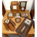 A collection of wall hanging barometers.