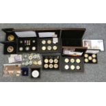 A quantity of cupro nickle and silver coins, some gilded and enamelled, mainly cased, together
