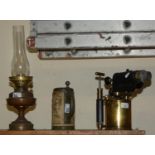 An ornate Victorian style Swediah plumbers blow torch, presentation inscription an oil lamp and a