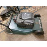 A Hayter Harrier 48 electric start petrol lawnmower, with basket, spare battery, charger and