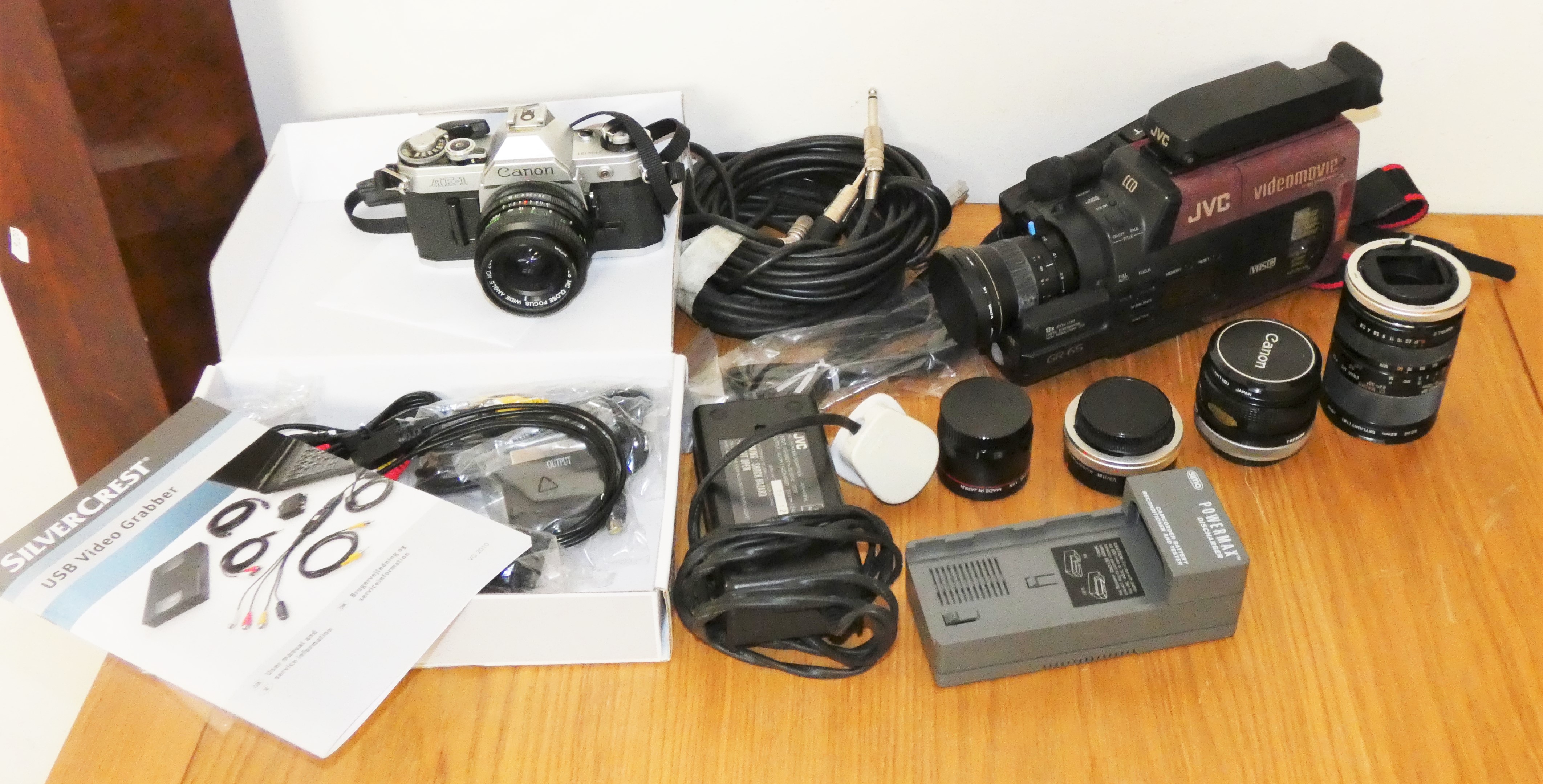 A collection of cameras and accessories, to include a Canon AE-1, Hoya 62mm + 55mm, skylight lenses,