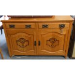 A light oak sideboard comprising of two drawers over two cupboards, 134cm long, 94cm tall, 47cm