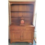 A light oak dresser with attached matching plate rack, 122cm long, 206cm tall, 43cm deep.