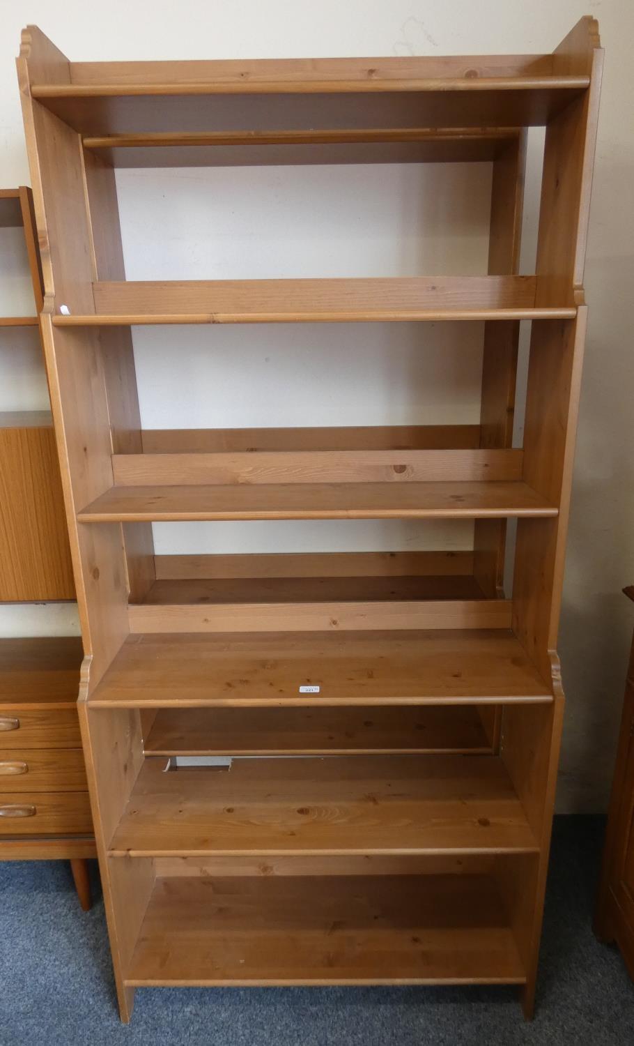 A pair of stained pine open bookshelves, 200cm tall, 93cm long, 33cm deep.