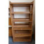 A pair of stained pine open bookshelves, 200cm tall, 93cm long, 33cm deep.
