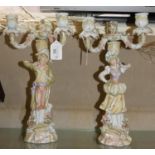 A pair of late 19th century German porcelain candelabra, three branch, the supports male and
