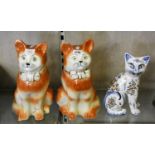 A pair of glazed Staffordshire seated tabby cat figurines, height 30cm, together with another cat