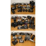 Three boxes of assorted cameras and lenses, to include Canon FT, Kodak Brownie 127, Praktica LTL3,