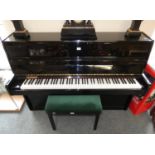 A Legnica upright piano, black lacquered, 104cm tall, 145cm long, 54cm deep, together with a piano