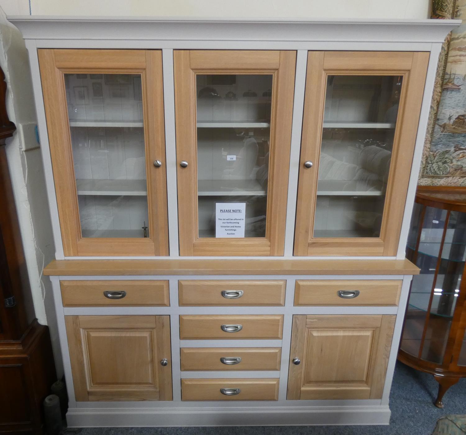 A Willis & Gambier glazed oak sideboard comprising of six drawers, flanked by two cupboards to the