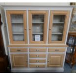 A Willis & Gambier glazed oak sideboard comprising of six drawers, flanked by two cupboards to the