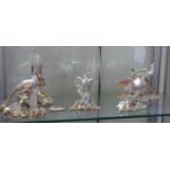A collection of five Royal Crown Derby bird figures to include three Chelsea Birds and two Peacocks,