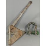 A galvanised steel CQR single flute anchor, with extra weight being placed in the tip of the