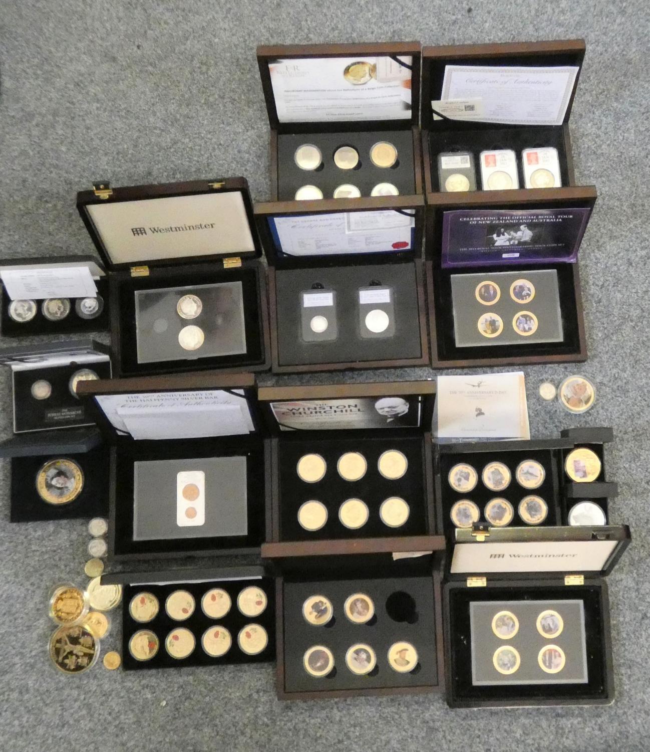 A quantity of cupro nickle and silver coins, some gilded and enamelled, mainly cased,