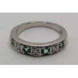 A 9ct white gold emerald and diamond half eternity ring, channel set with brilliant cut stones, size