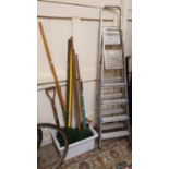 A quantity of garden tools and two step ladders.