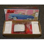 A boxed Japanese model of a circa 1950's Buick car, apparently unused