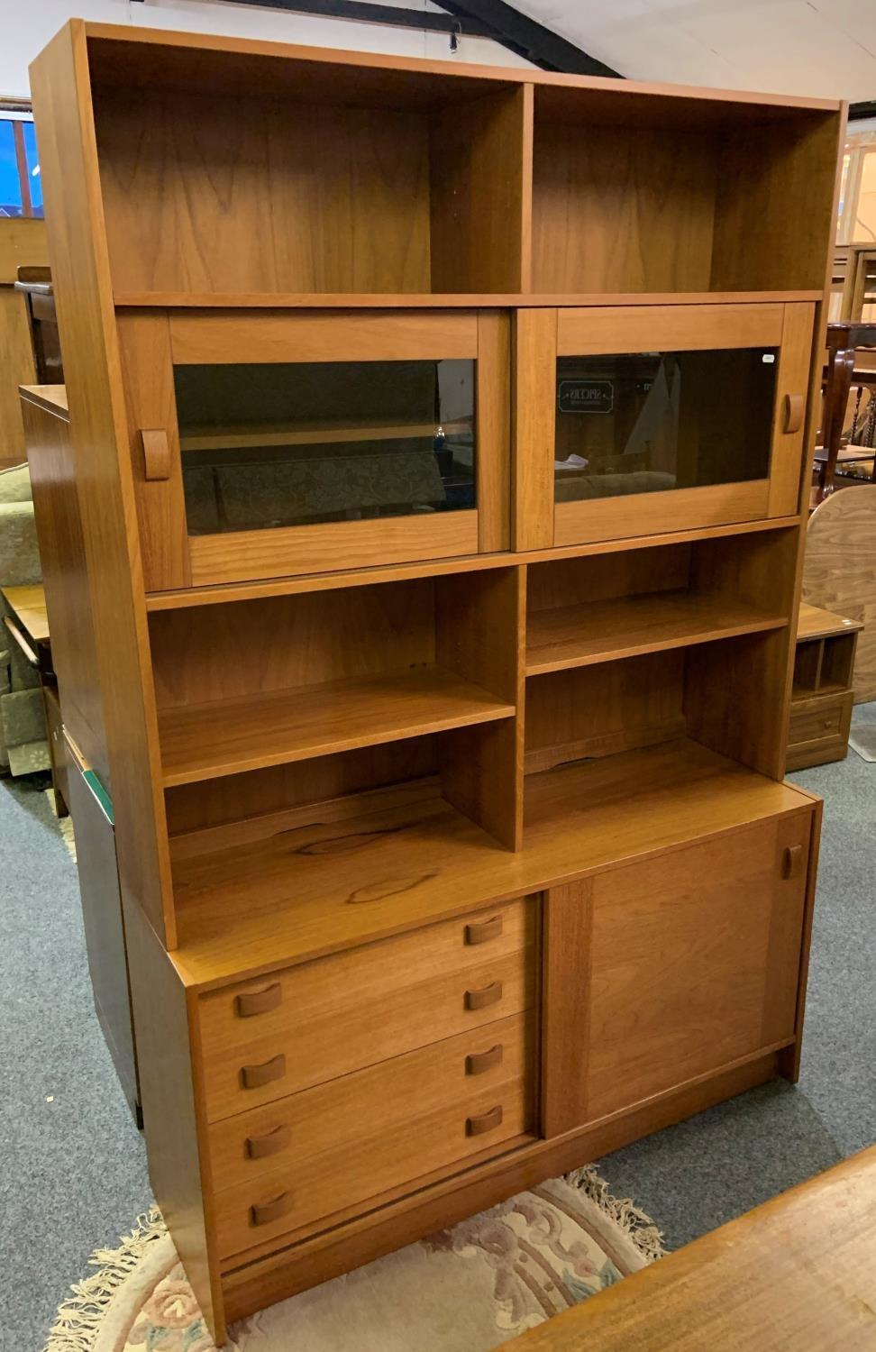 A quality teak wall unit, 122 x 184 cm, the top comprising of open shelves over display area