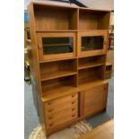 A quality teak wall unit, 122 x 184 cm, the top comprising of open shelves over display area