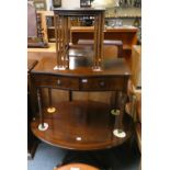 A mahogany oval coffee table, a mahogany twin drawer side table and a mahogany nest of tables (3).