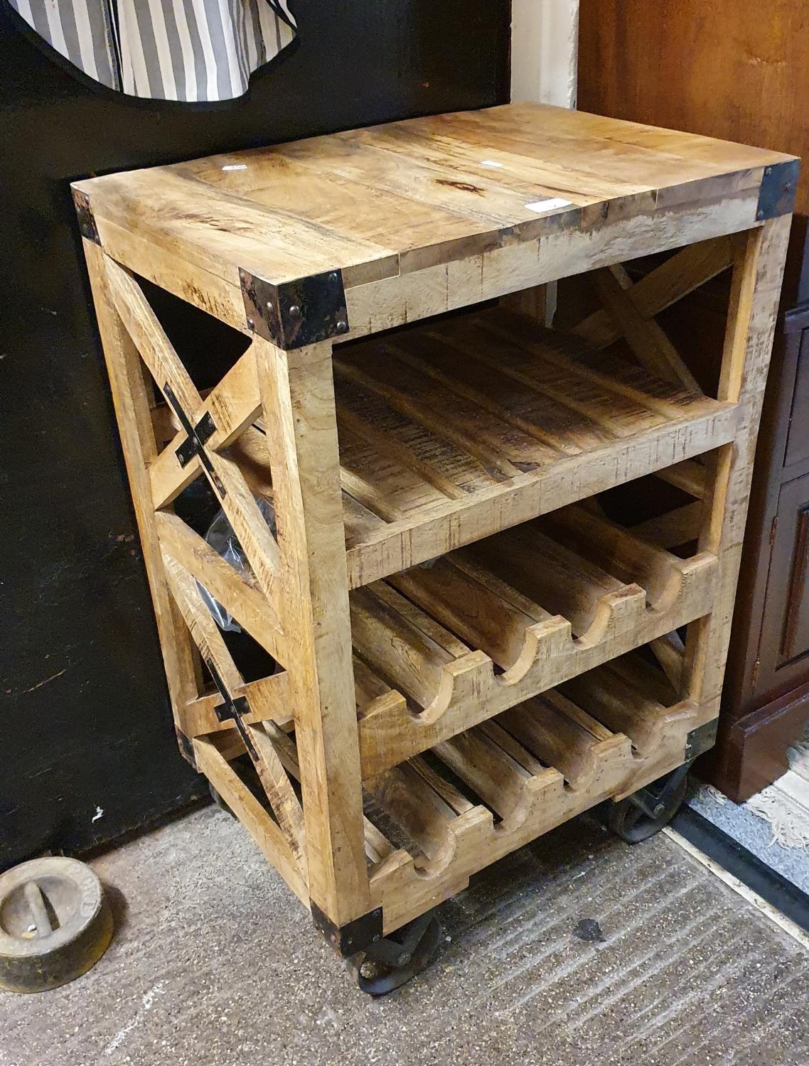 An industrial style wine rack/island unit, with metal straps and wheels, 60 x 41 x 90 cm.