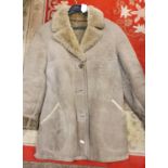 A Maltese sheepskin ladies coat, size 16 and a fur coat (2).